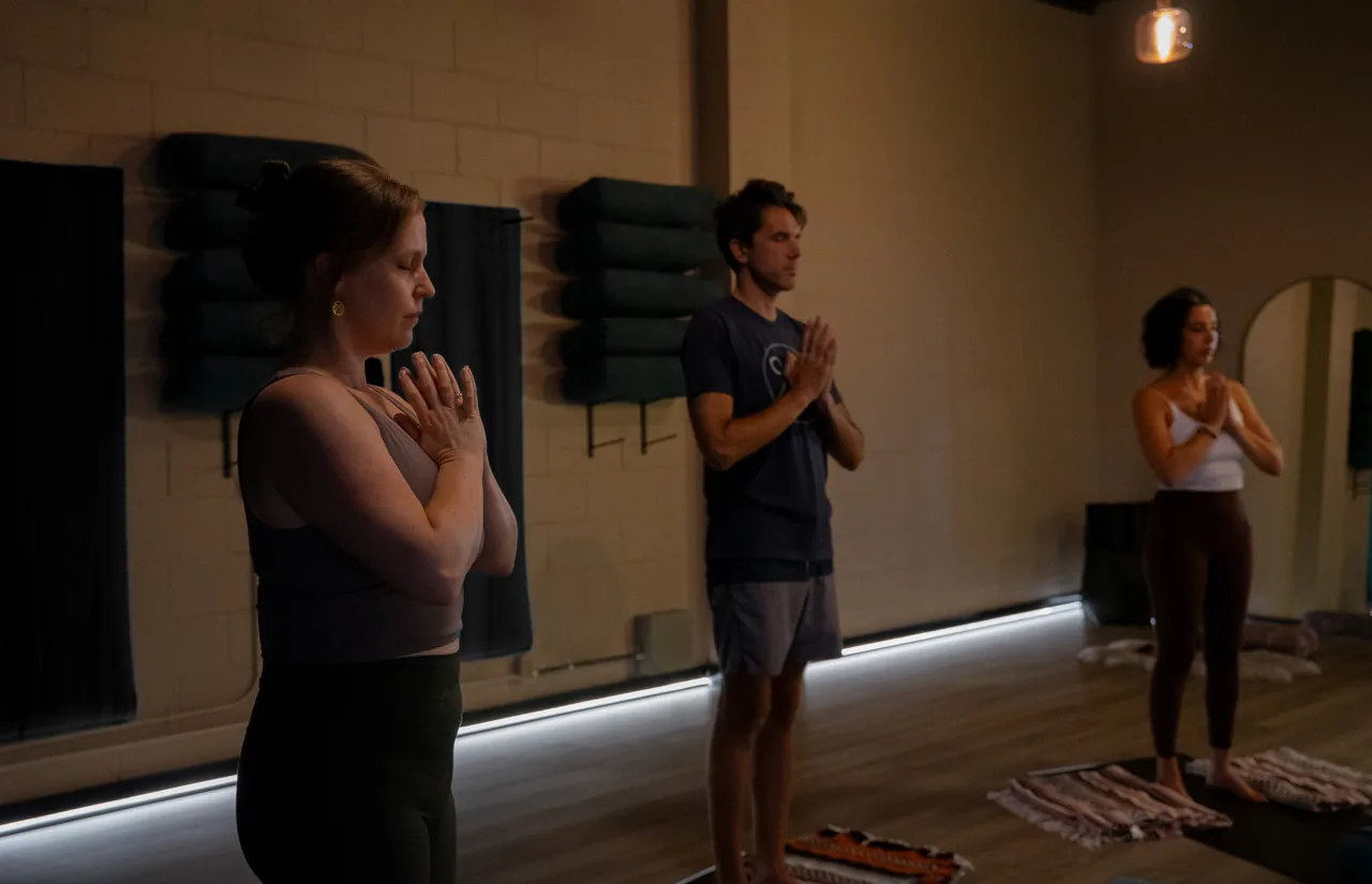 Students standing with a hand on their heart during class