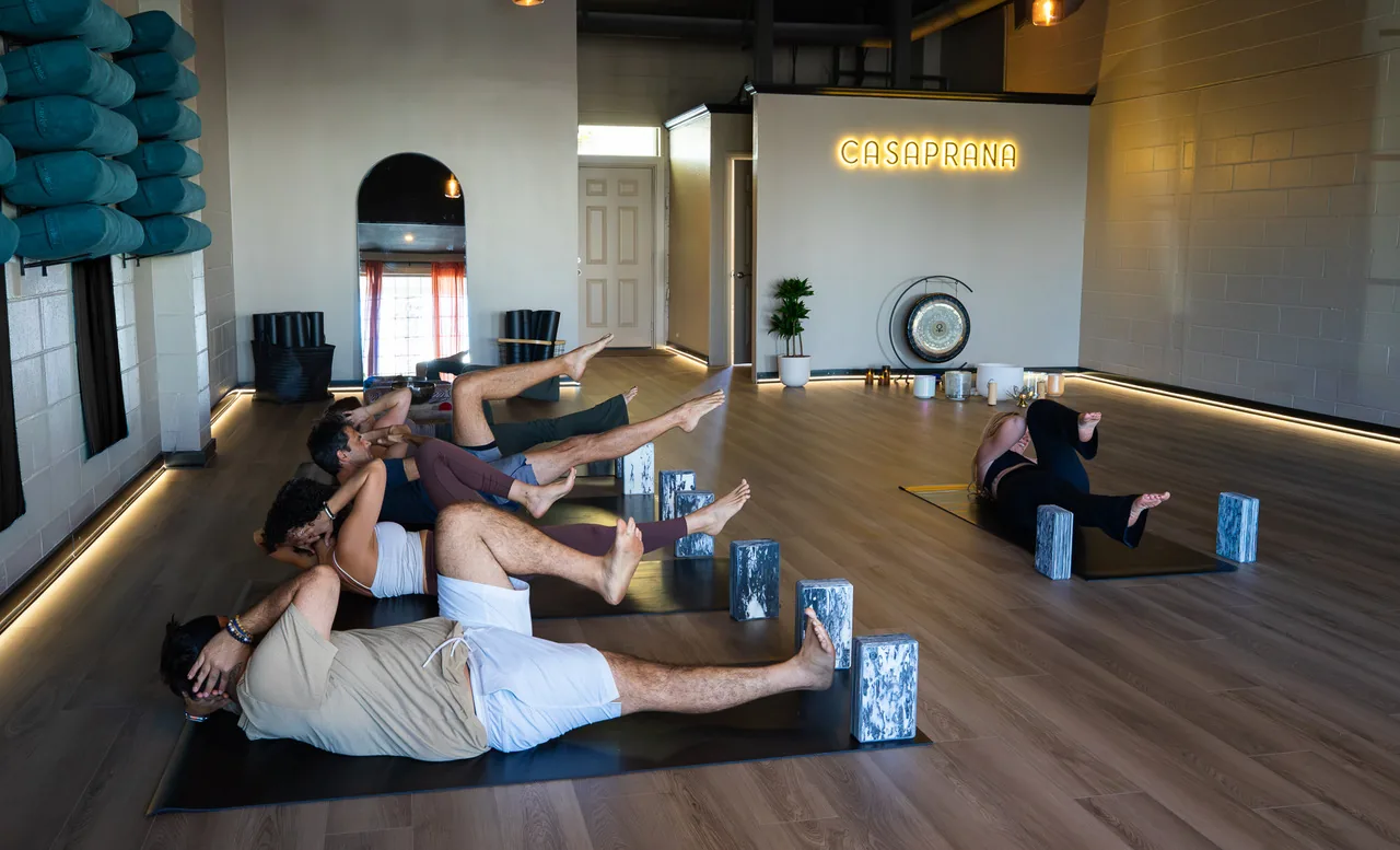 A Pilates class working on their mats at CASAPRANA